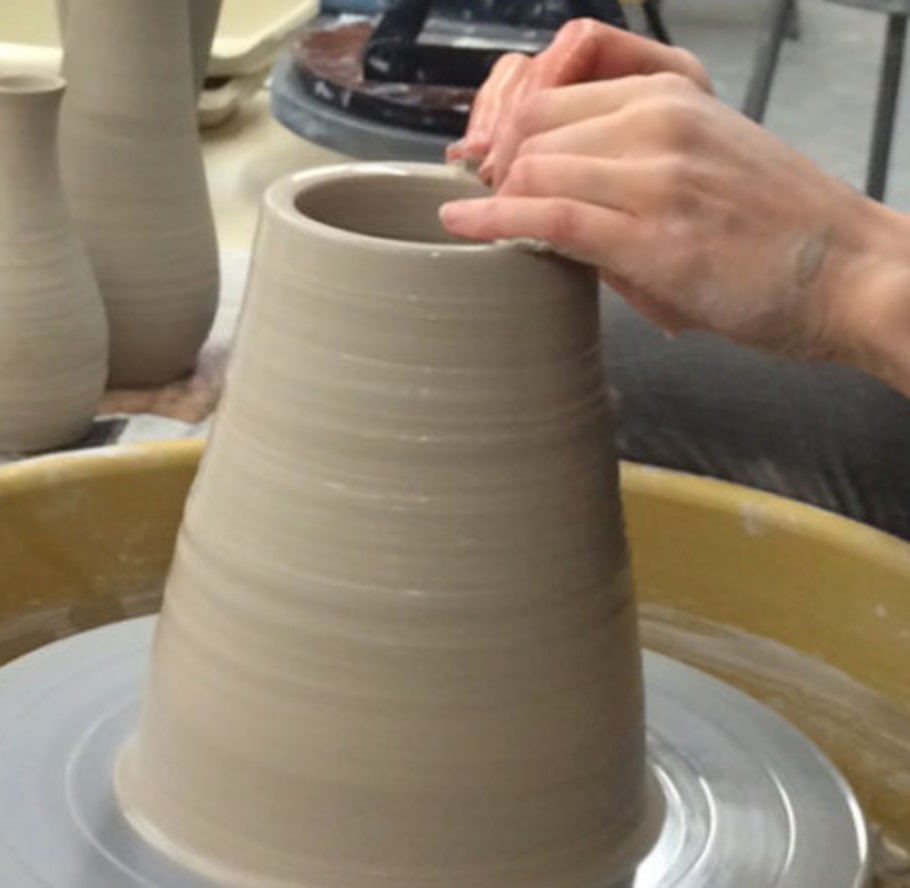 A pot being thrown on the wheel