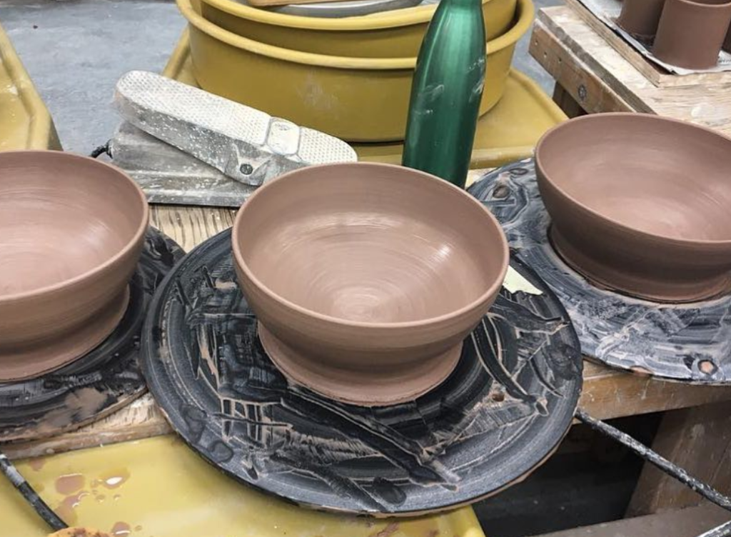 Clay bowls being thrown on the wheel